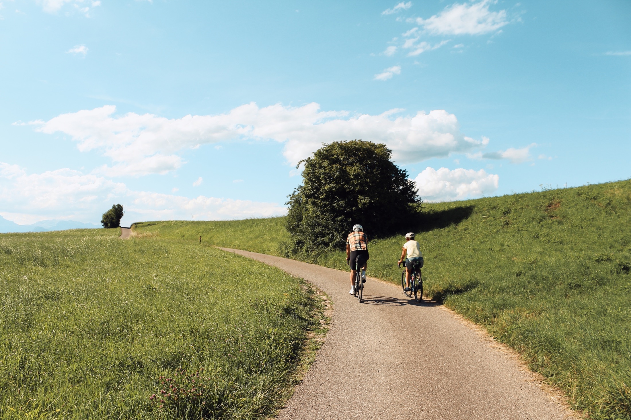Fully loaded bikepacking bicycle on a scenic gravel road at golden hour